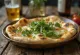 Postrežen naan kruh s kozjim sirom in rukolo