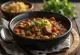 Pozole con chile pasilla postrežen z limeto, koriandrom in mlado čebulo